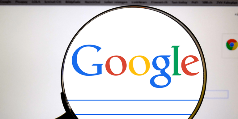 A magnifying glass over the Google homepage.
