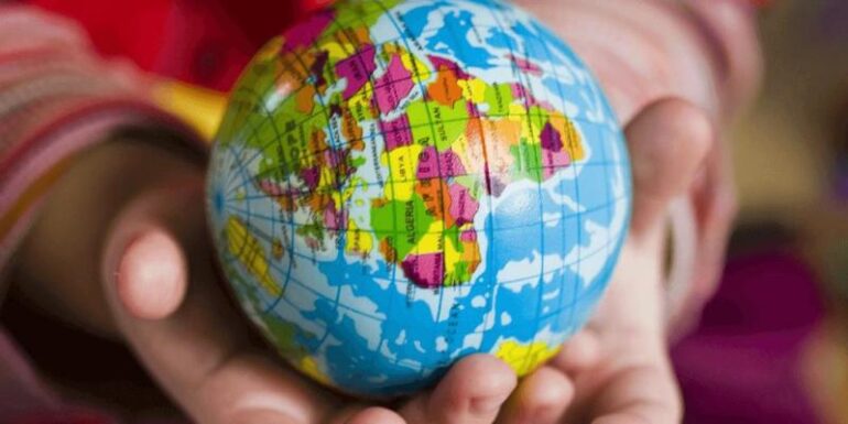 Hands holding a globe.